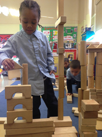 Photo of a child playing with wooden blocks