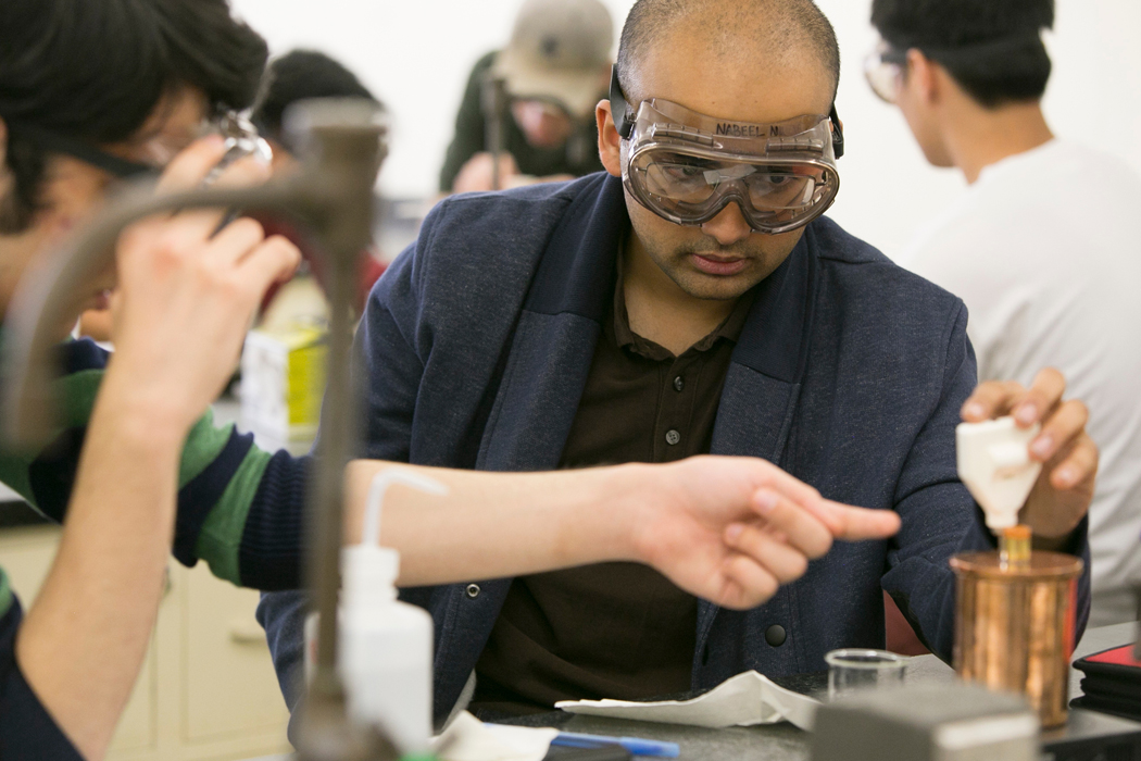 Science Student in class with a beaker 