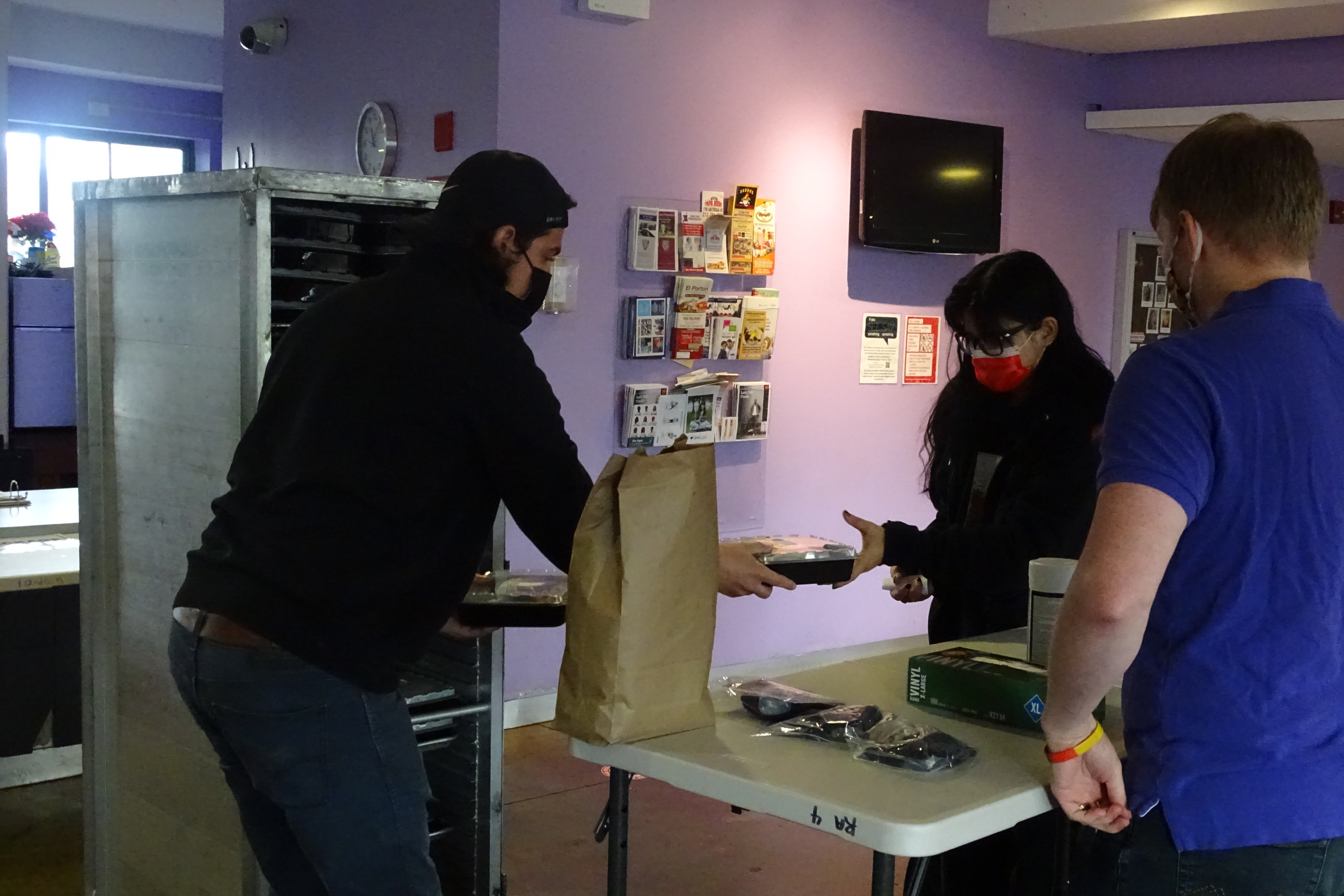 Personal Touch employee (left) distributes meal to Towers resident.