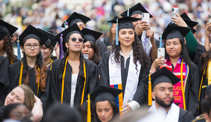 Students standing at Commencement 
