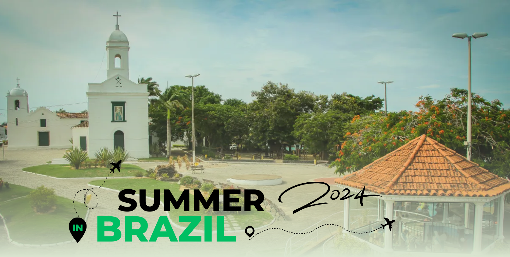 A church with a clock tower and a green lawn, known as Igreja Matriz.