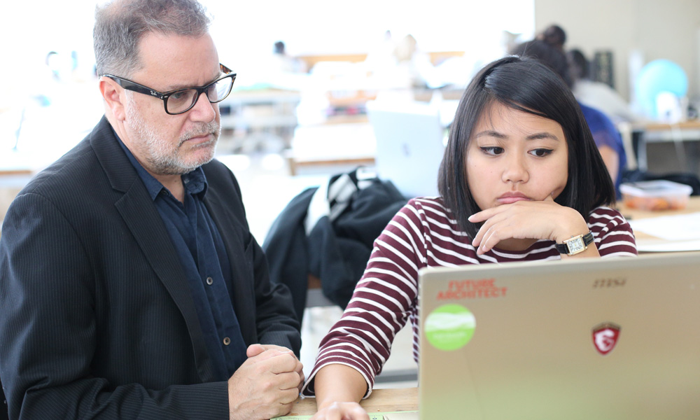 Student and professor looking at computer screen