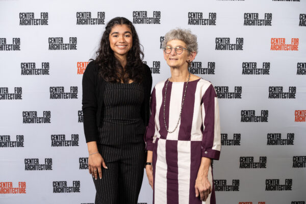 A photo of two women standing side by side smiling.