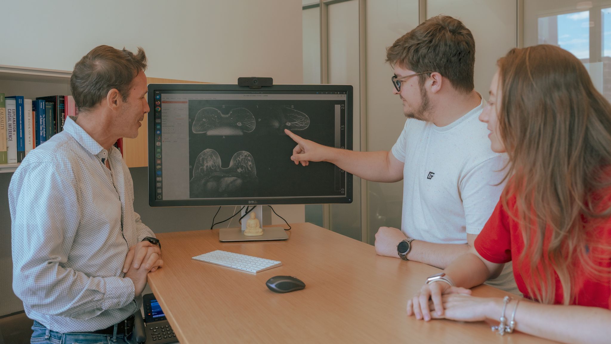 Professor Lucas Parra with students reviewing breast cancer MRI scans