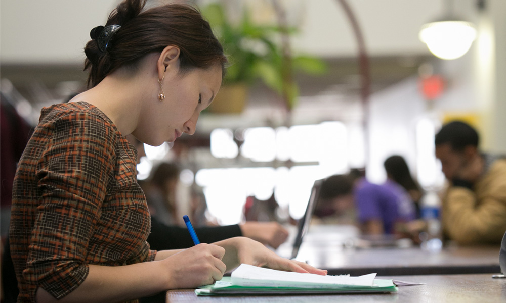Student writing on a paper