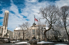 Photo of the Quad in Winter with Snow on the Ground and an American Flag Flying