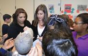 Graduate students interacting with children