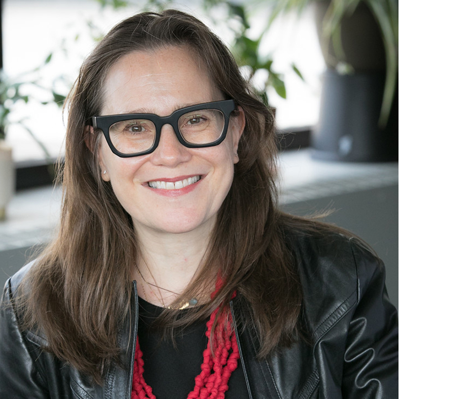 Headshot of Dr. Irina Silber, who has long brown hair and is wearing glasses.