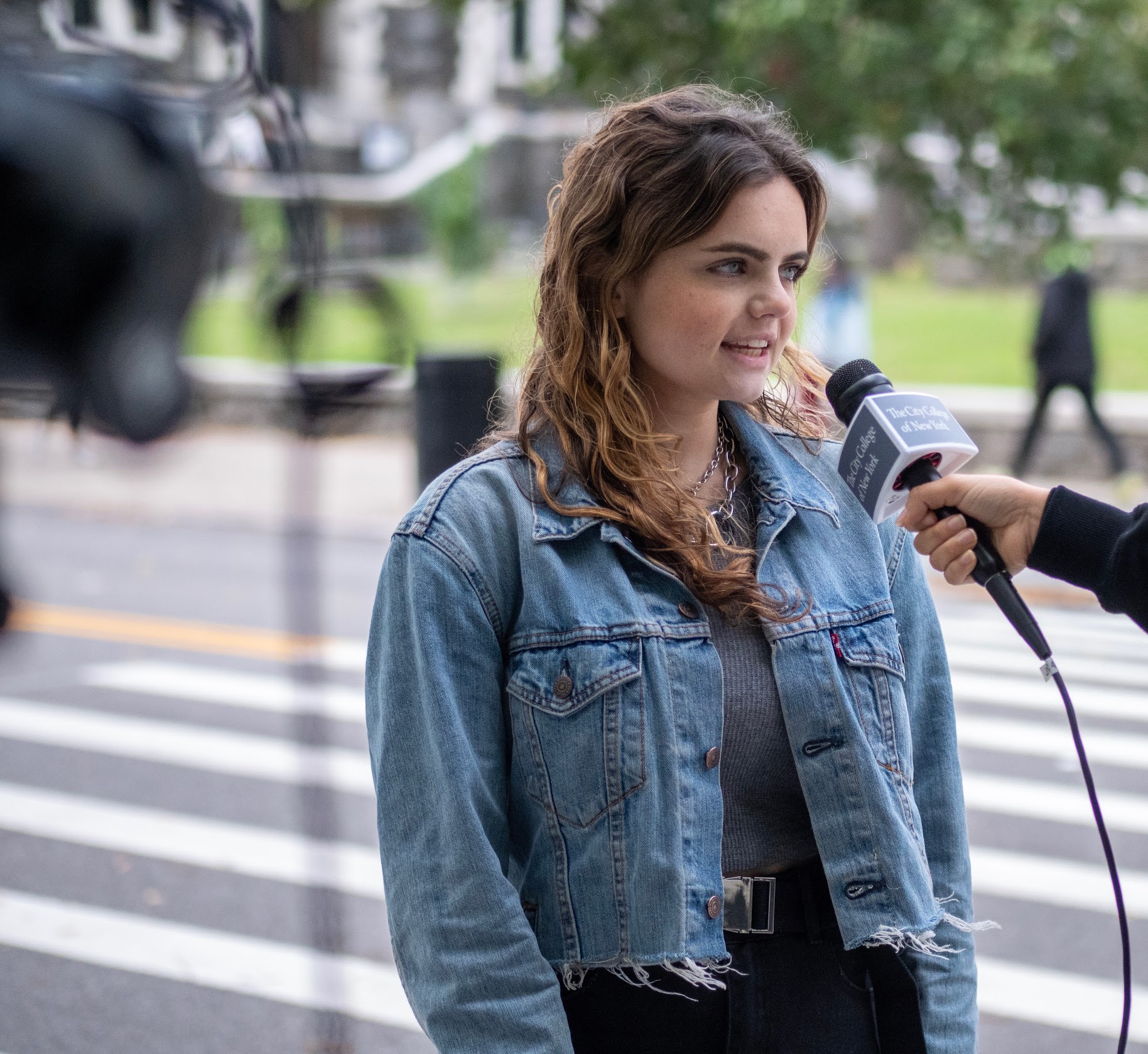 A student is interviewed on campus for a story.