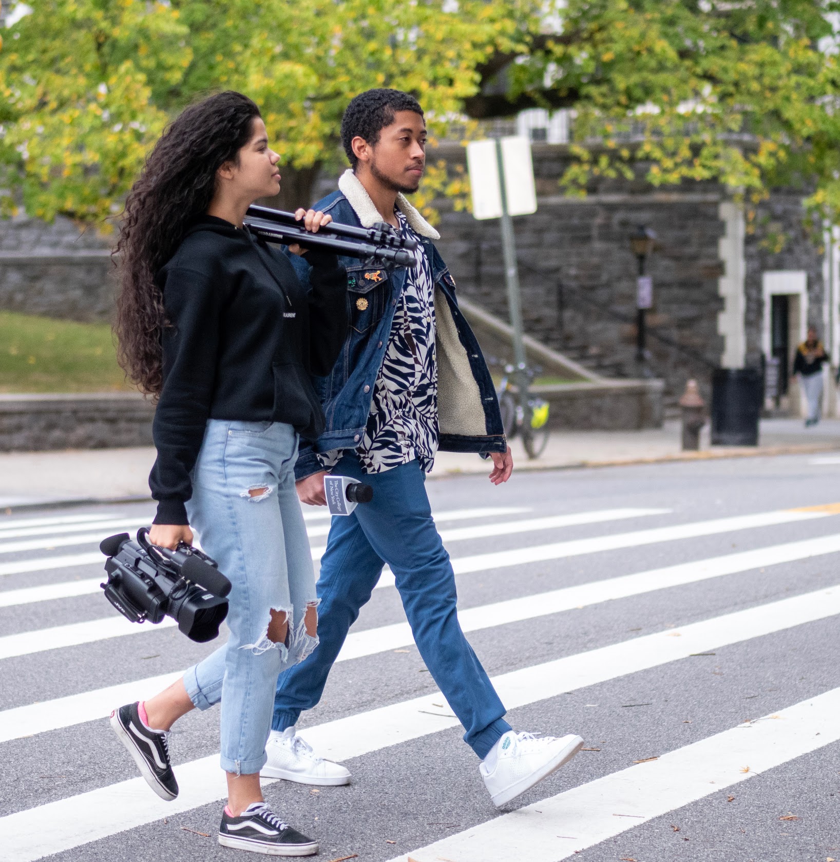 Journalism students with a camera crossing Convent Avenue