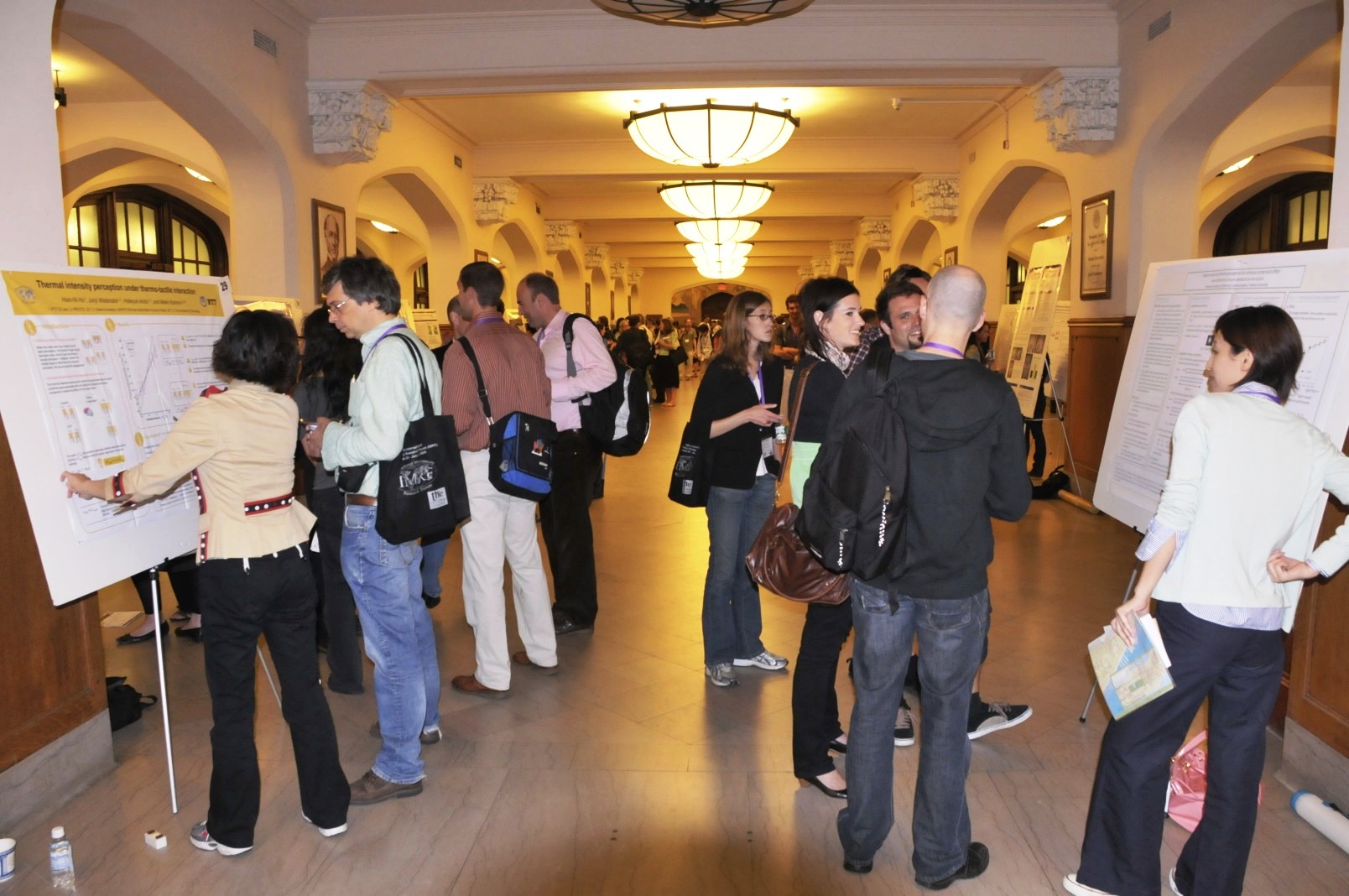 Delegates to the 10th annual meeting of the International Multisensory Research Forum view poster session in the Lincoln Corridor of Shepard Hall.