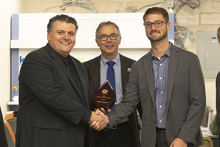 Professor Angelo Lampousis (left) with Tony M. Liss, provost and senior vice president for Academic Affairs, and Travis Murdock, ASTM International.