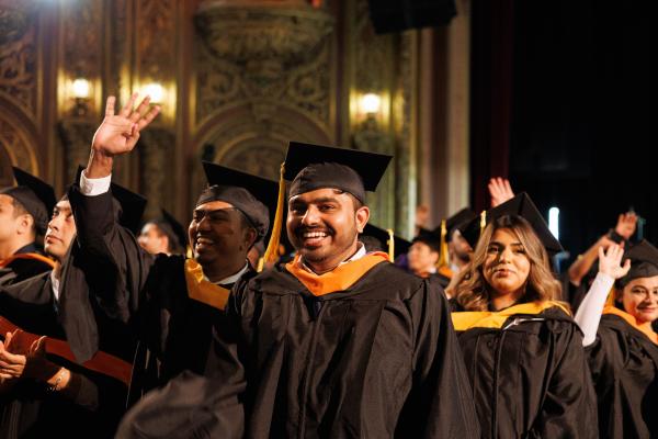 Group of Colin Powell School Students pose and smile for the camera at the United Palace Theatre