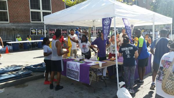 CCNY participants gather around the information booth.
