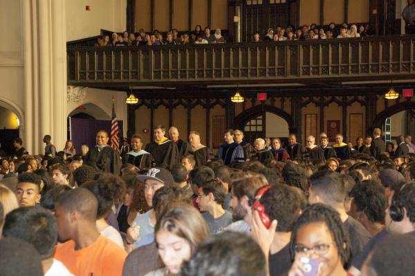 The freshman class sits and watches faculty, staff and administrators as they walk down the aisle of the Great Hall for Freshman Convocation.