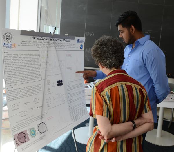 Kassim Inzamamdeen presents the lessons he learned about melanin research to Professor Ruth E. Stark
