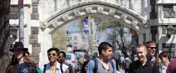 Photo of a group of students walking to class under the archway