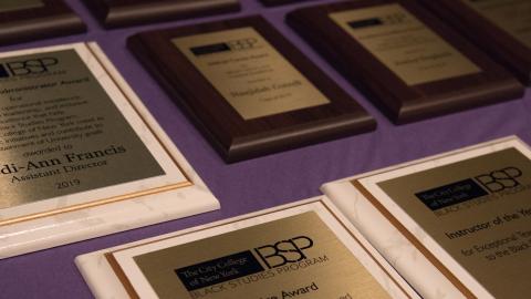 Awards laid out on the table. the table is a purple color 
