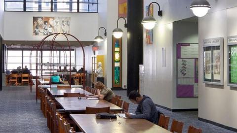 students study at tables in the library