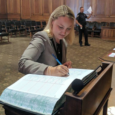 Skadden Student singing a book