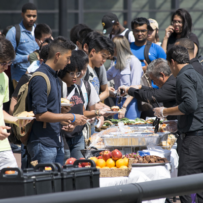Students on campus waiting on line to get food.