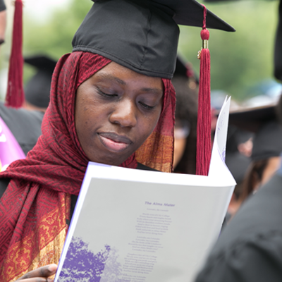 Student reading Commencement book