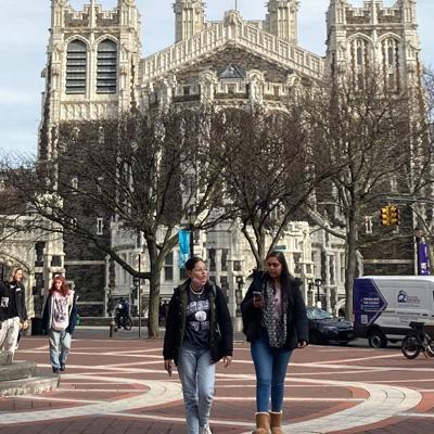Two students walking on campus