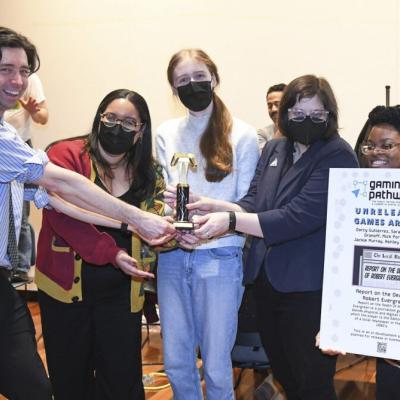 Director of the Digital Game Development Program Nicholas Fortugno is awarding graduate students from the Urban Arts Program the “Most Anticipated Game of Unreleased Games Arcade 2025” at the Unreleased Games Arcade (UGA).