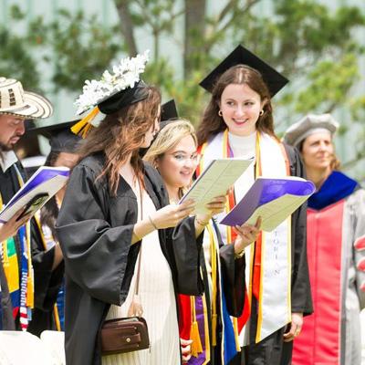 Students Holding Commencement Book
