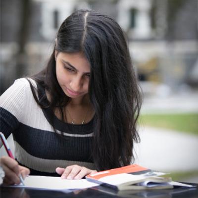 Student writing in notebook