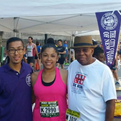 Sarai Perez (second from the right) and fellow runners at the CCNY information booth before the 5K run.