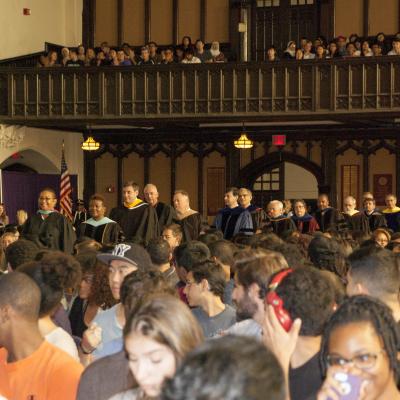 The freshman class sits and watches faculty, staff and administrators as they walk down the aisle of the Great Hall for Freshman Convocation.