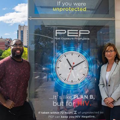 Victoria Frye and Jeremy Fagan in front of PEPTALK ad