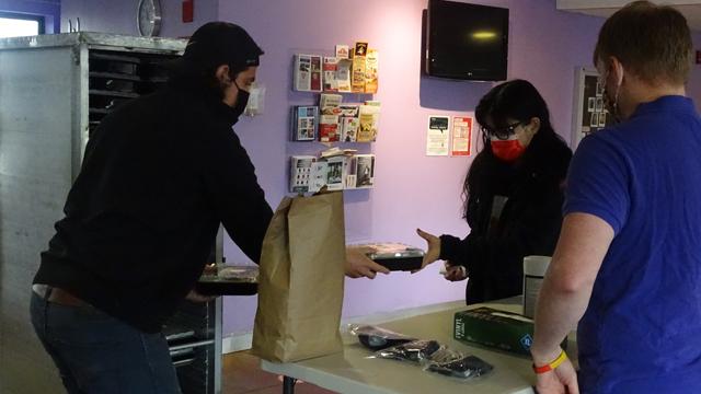 Personal Touch employee (left) distributes meal to Towers resident.