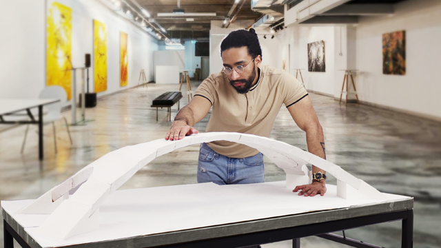 Student Ahmed Helal who's examining a scale model of Leonardo Da Vinci's unbuilt Galata bridge.