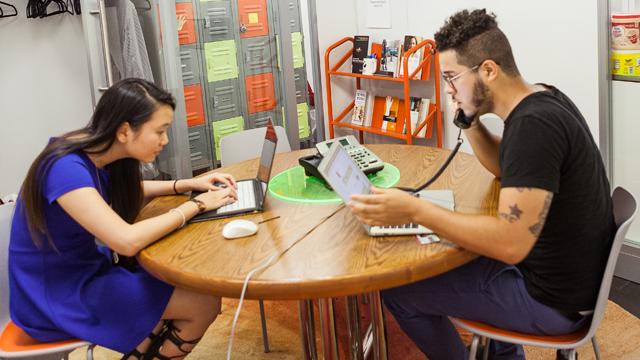 Two students working on their laptop