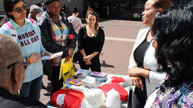 Join us on Sept. 28 for WHCR's Harlem Emergency Preparedness Day and discover a range of emergency preparedness topics. Group of people talking in front of a table
